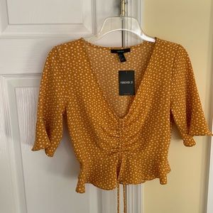 Yellow and white polka dot shirt